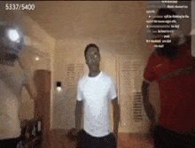 a man in a white shirt is dancing in a room with the number 5337/5400 on the bottom right