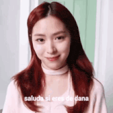a close up of a woman with red hair and the words saluda si eres de dana