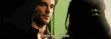 a man and woman are looking at each other and the man says i 'm in love with you .