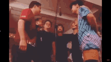 a group of young men are standing in a circle .