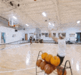 a man in a white shirt is playing basketball on a court