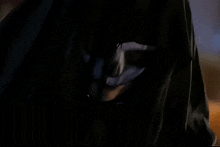 a painting of a person in a black hooded cloak