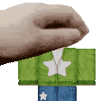 a person is holding a green shirt with a white star on it and blue jeans .