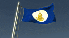 a blue and white flag with a gold anchor