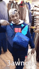 a man wearing a hat and a blue louis vuitton bag is standing in a clothing store .