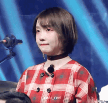 a girl wearing a plaid shirt and a choker has sudo_root written on the bottom of her photo