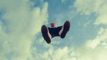 a person is flying through the air wearing a shirt that says ' converse '