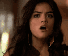 a woman is making a surprised face with her mouth open