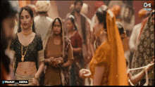 a woman in a crop top stands in a crowd of people with the hashtag pranay_varma on the bottom