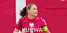 a female soccer player in a pink kurwa jersey