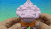 a person is holding a toy that looks like a fat man