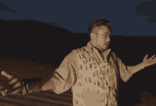 a man with his arms outstretched wearing a vest with the letter u on it