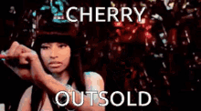 a woman is writing the word cherry outsold on a piece of paper .