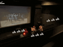 a group of people watching a movie with oh oh oh written on the bottom