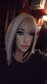 a woman in a wig is taking a selfie
