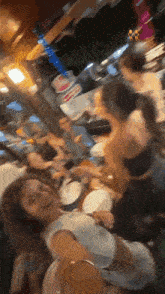 a group of people are sitting at a table in a restaurant eating and drinking .