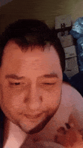 a man with a beard is making a funny face