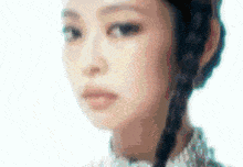 a close up of a woman 's face with braids .