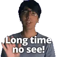 a man wearing glasses says long time no see with his hand