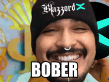 a man with a beard wearing a black beanie with the word blazzard on it
