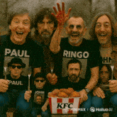 a group of men wearing paul and ringo shirts holding forks and a bucket of kfc nuggets