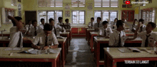 a group of students in a classroom with the words terbaik ke langit on the bottom right