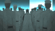 a group of men in white uniforms and hats are standing in a row