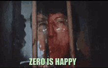 a man with glasses behind bars with the words zero is happy below him