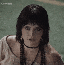 a close up of a woman wearing a choker and earrings