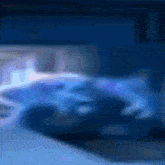 a blurry picture of a blue background with a white object in the middle