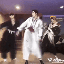 a group of people are dancing in a room with a purple background and the word vaggiero on the bottom