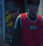 a person wearing a red vest with the number 24 on it