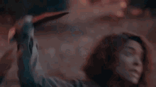 a woman with red hair is screaming with her mouth open in a close up of her face .