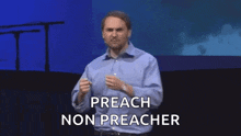 a man in a blue shirt is giving a speech on a stage and says preach non preacher .
