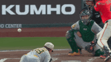 a baseball game is being played in front of a kumho advertisement
