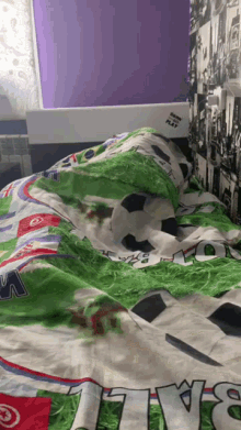 a bed with a soccer theme and the word play on the headboard