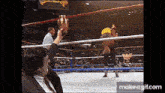a man in a suit is holding a trophy in a boxing ring