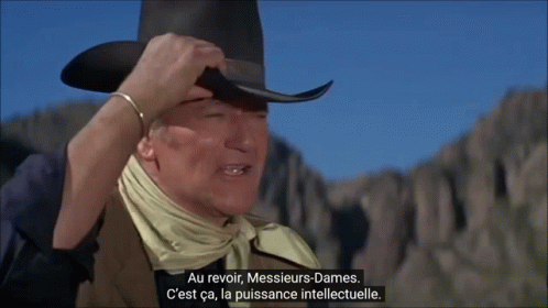 a man wearing a cowboy hat and a bandana is talking in a foreign language