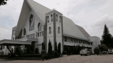 a white building with a roof that is very tall