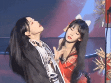 two girls are dancing on a stage and one of them has a cat ear on her head