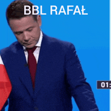 a man in a suit is kneeling at a podium with the words bbl rafal written above him