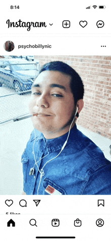 a man is smoking a cigarette while wearing ear buds on his phone