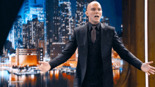 a man in a suit and tie stands in front of a city skyline with the hashtag #superman on the bottom