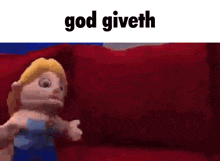 a cartoon character is sitting on a red couch with the words god giveth above it .