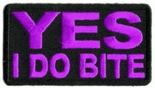 a purple patch that says `` yes i do bite '' on a black background .