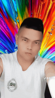 a man taking a selfie with a colorful background and a sticker that says tik tok