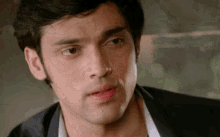 a close up of a man 's face with his mouth open and a serious look on his face .