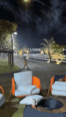 a person walking down a street at night with a blurred background