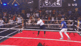 a man in a suit is standing in a wrestling ring