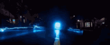 a blue lightning bolt is coming down a dark street .
